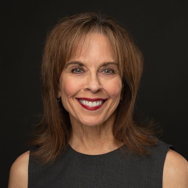 Smiling woman with shoulder-length brown hair.