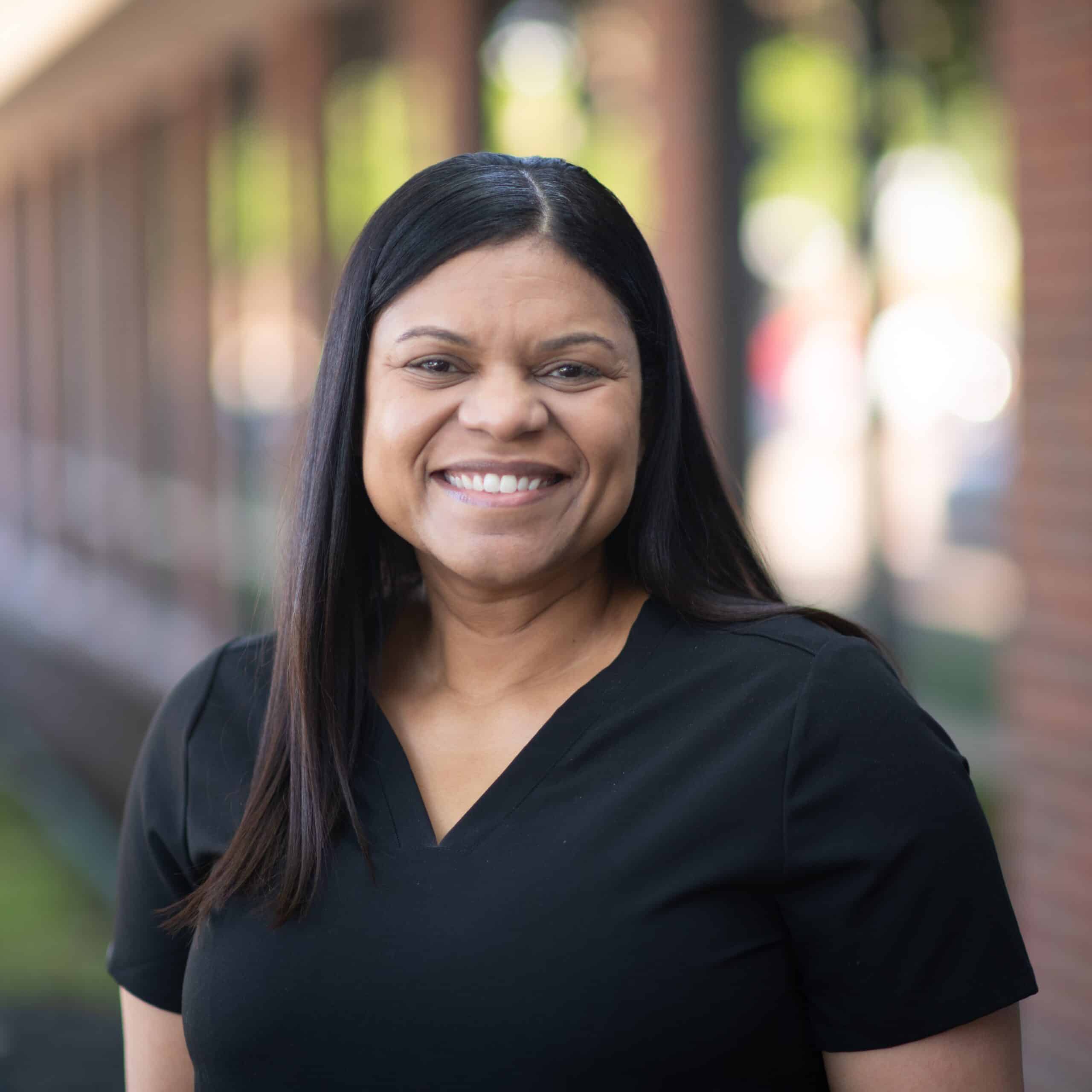 Smiling woman in black shirt outdoors