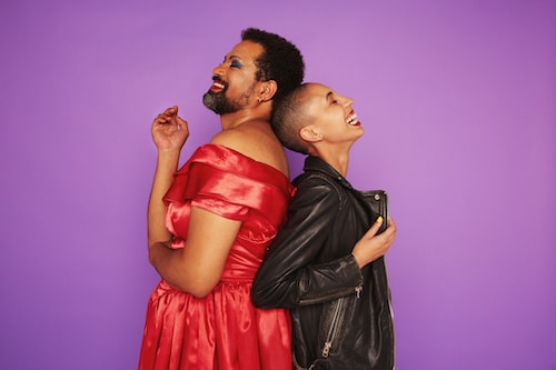 lgbtq friends smiling on purple background