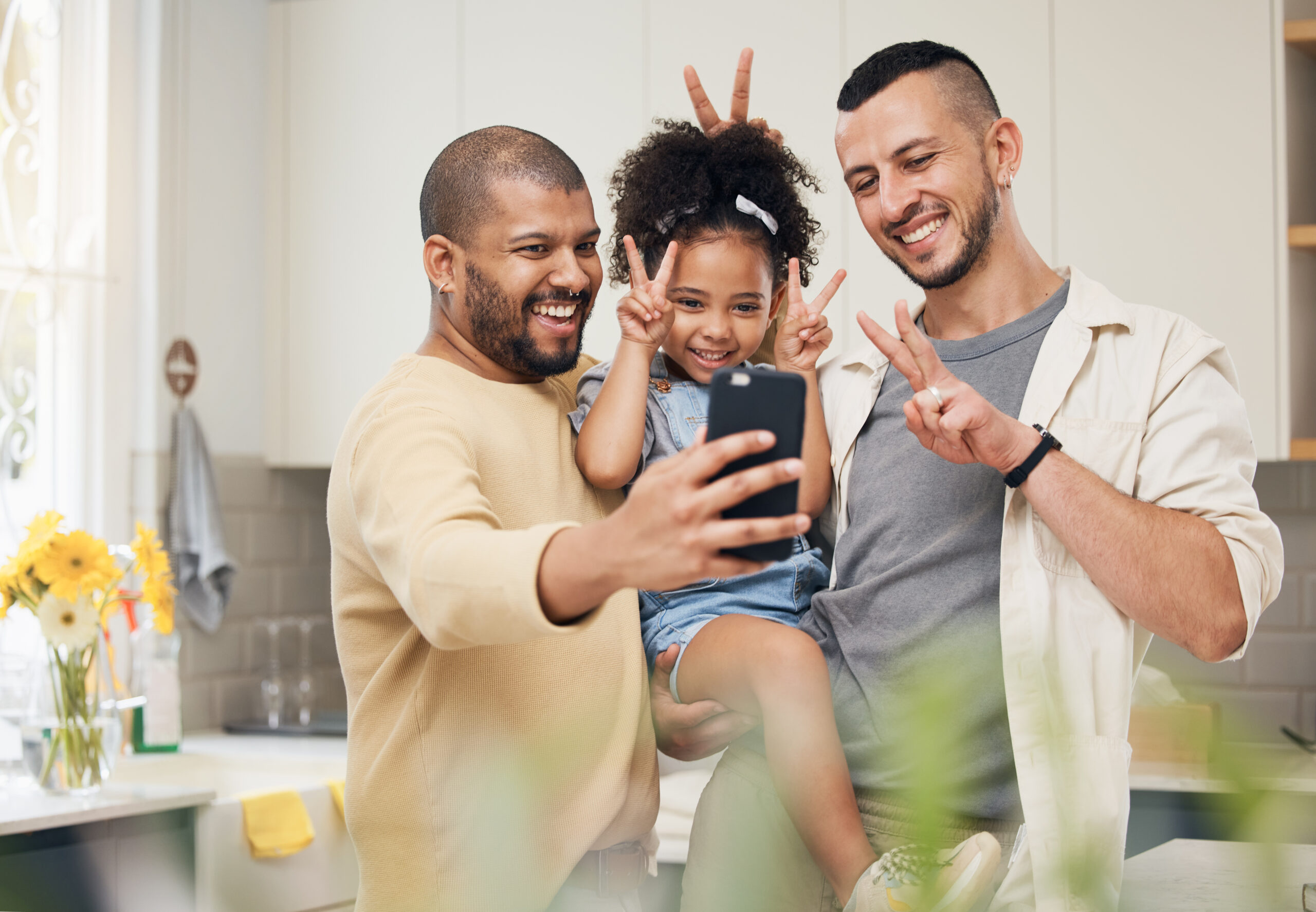 selfie, blended family and a happy girl with her gay parents in the kitchen together for a profile picture. adoption photograph, smile or love and a playful daughter with her lgbt father in the home