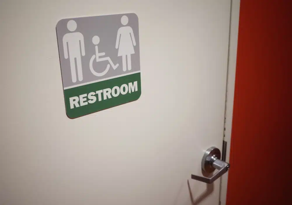 Accessible restroom sign on door