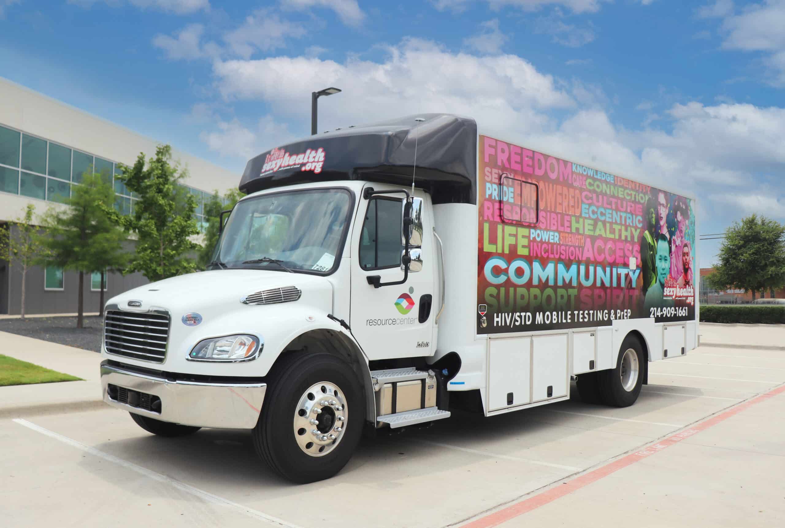 HIV/STD mobile testing van parked outside building.